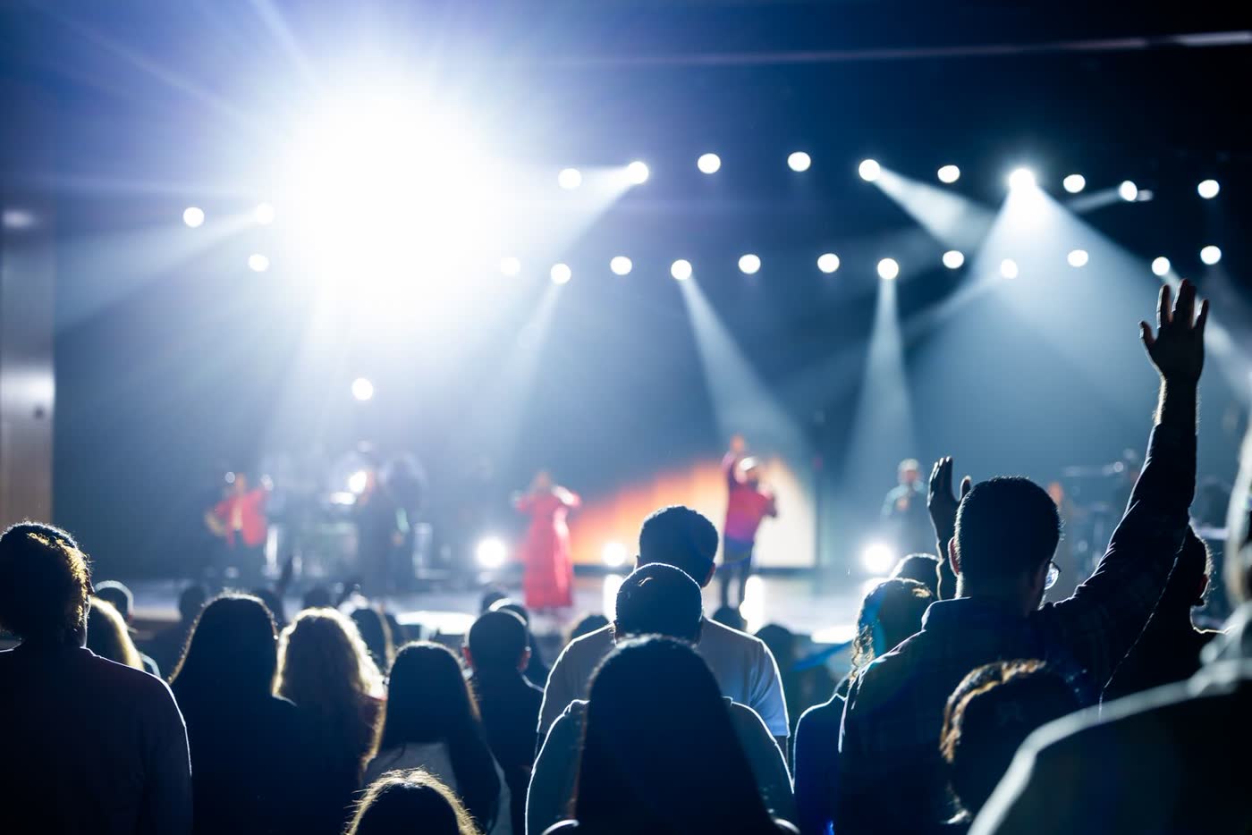 Concert audience under vibrant stage lights