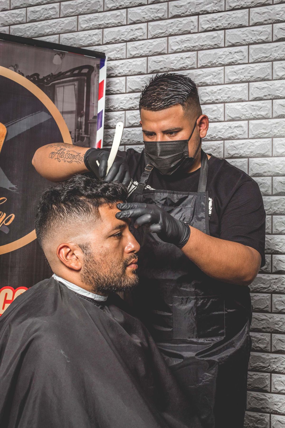 A barber part-way through detailing an edge.