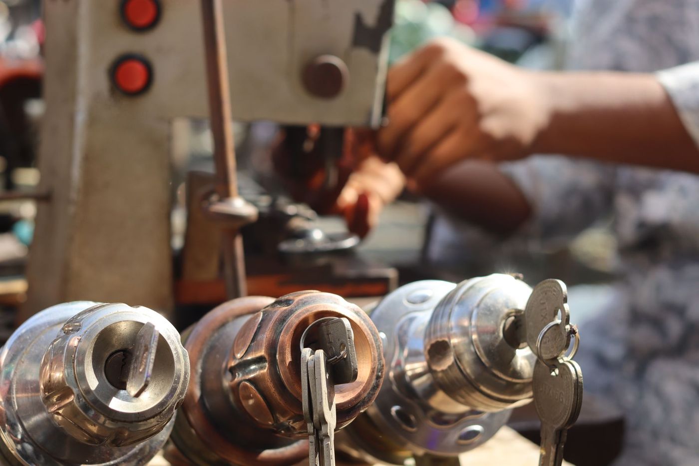 A key-cutting machine with lock cylinders lined up in front of it